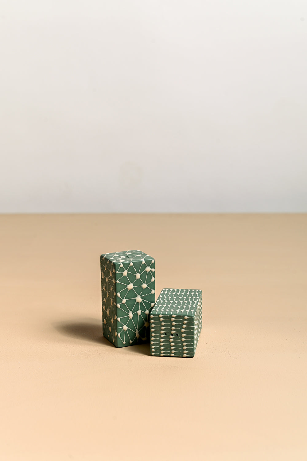 A pair of ceramic salt and pepper shakers with a geometric pattern 