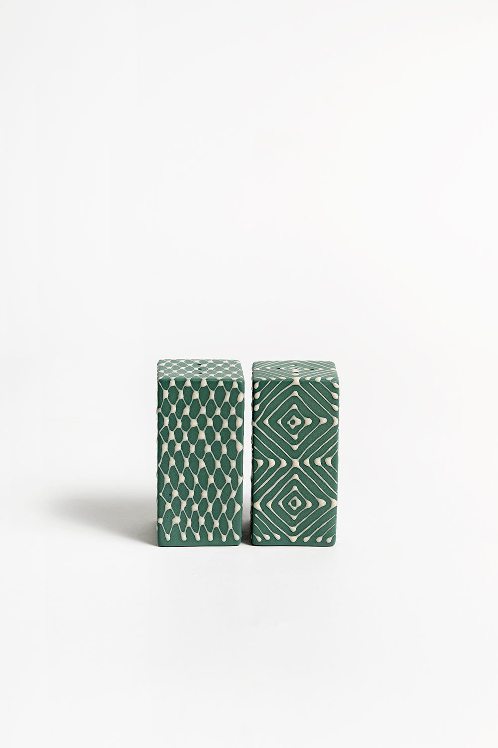 A pair of ceramic salt and pepper shakers with a geometric pattern 