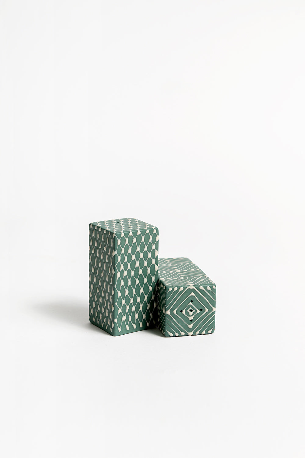 A pair of ceramic salt and pepper shakers with a geometric pattern 