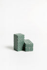 A pair of ceramic salt and pepper shakers with a geometric pattern 